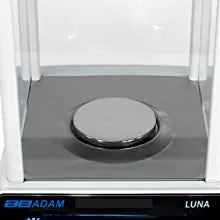 Close up view of weighing platform of Adam Luna analytical laboratory scale