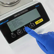 Scale in use with sample container placed on pan of Kern analytical scale