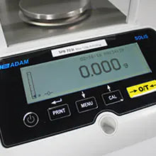Device on lab bench with draft shield visible of Kern precision balance